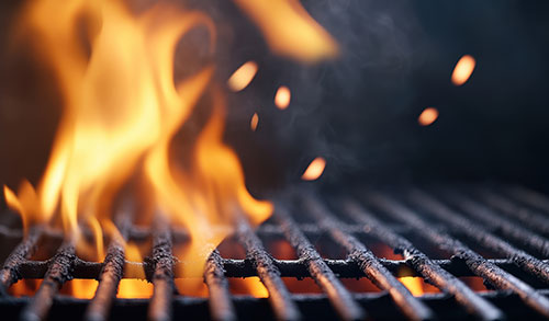 Closeup of fire on a cooking grill.