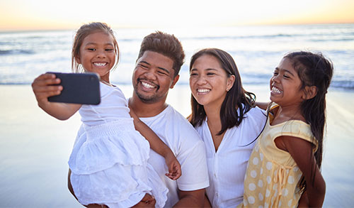 Family takling selfie on bearch