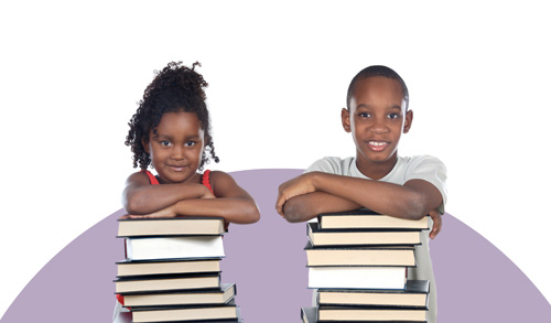 Young boy and girl each leaning on a stack of books